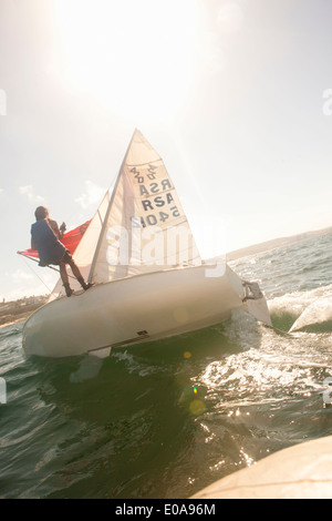 Teenager sailing boat Stock Photo