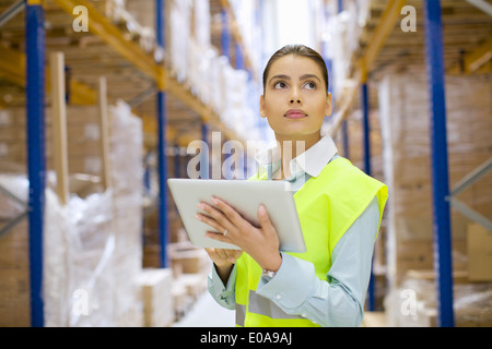 Female warehouse worker using digital tablet Stock Photo