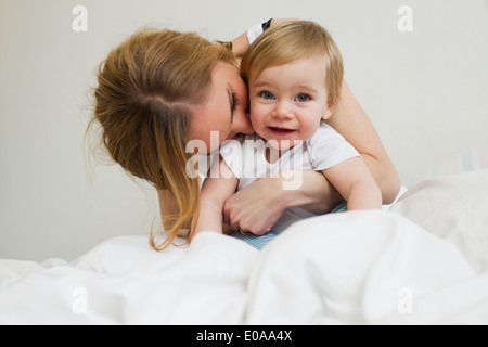 Portrait of mid adult woman hugging her year old baby girl Stock Photo