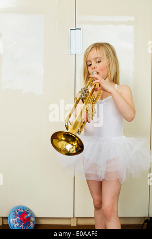 Portrait of young girl playing the trumpet Stock Photo