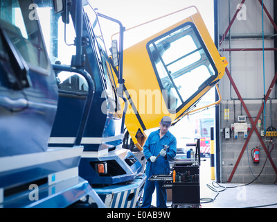 Engineer working on engine in truck repair factory