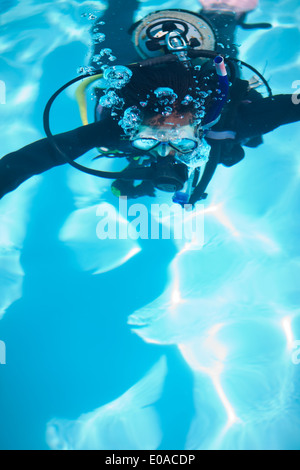 Young female scuba diver training in swimming pool Stock Photo