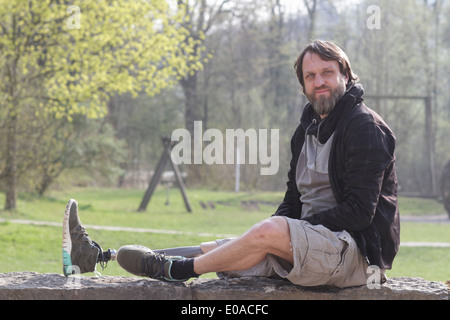 Portrait of man with prosthesis leg in park Stock Photo