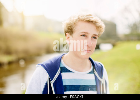 Portrait of teenage boy by rural river Stock Photo