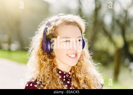 Portrait of teenage girl listening to headphones Stock Photo