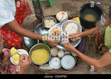 Eating food at the market Mrauk U Rakhine State Myanmar Stock