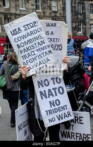 A demonstrator is almost completely hidden by signs at a May day Rally in Edinburgh, Scotland, UK. Stock Photo