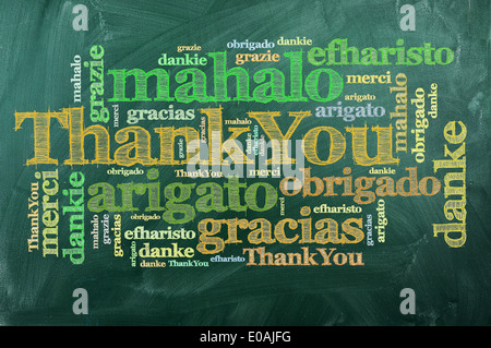 thank you in different languages on green chalkboard Stock Photo