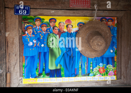 A painted poster of Chinese military leaders and Mao hangs in a rural house, Yunnan, China Stock Photo