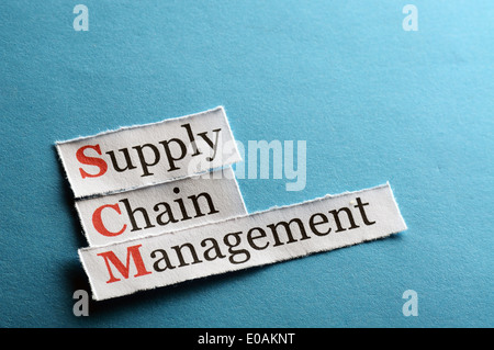 SCM Supply Chain Management acronym on blue paper Stock Photo