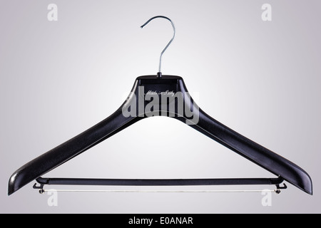 a black plastic clothes hanger isolated over a white background Stock Photo