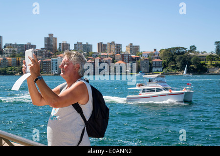 Sydney Australia,Sydney Harbour,harbor,water,Parramatta River,Kirribilli,neighborhood,Lower North Shore,boat,man men male,taking tablet,iPad,camera,AU Stock Photo