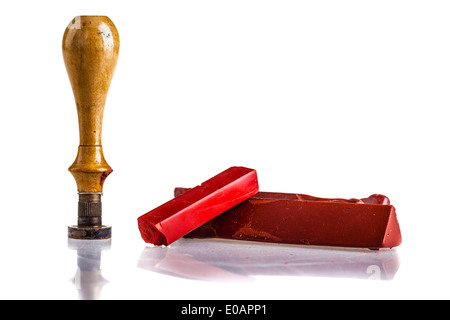 red sealing wax sticks, a wooden seal and an envelope isolated over a white background Stock Photo