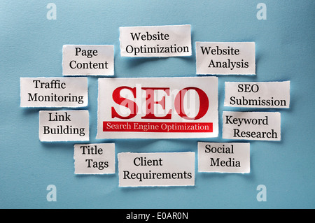 SEO Word Cloud printed on paper on blue  Stock Photo