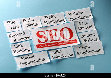 SEO Word Cloud printed on paper on blue  Stock Photo