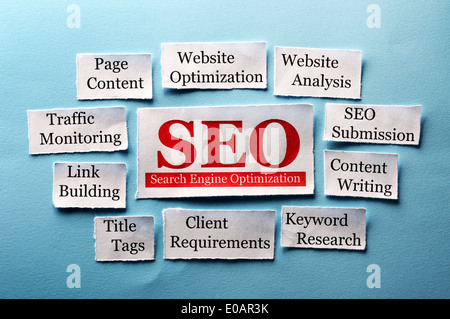 SEO Word Cloud printed on paper on blue font Stock Photo
