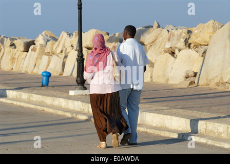 Tunisia, young couple takes a walk in the tourist port of Sidi Bou Said Stock Photo