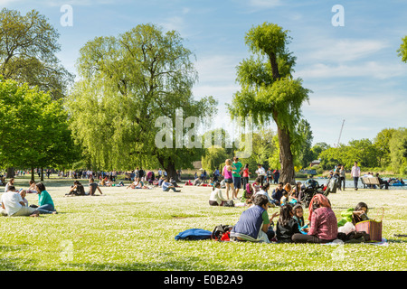 Young people relaxing in the summer sunshine, Regents Park London Stock Photo