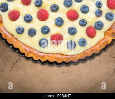 Tart with blueberries and raspberries on old table Stock Photo