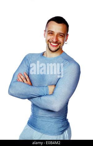 Smiling handsome trainer with arms crossed in gym Stock Photo - Alamy
