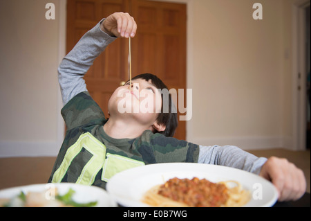 Boy playing with spaghetti Stock Photo