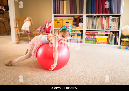 Portrait of cute young girl on top of exercise ball Stock Photo