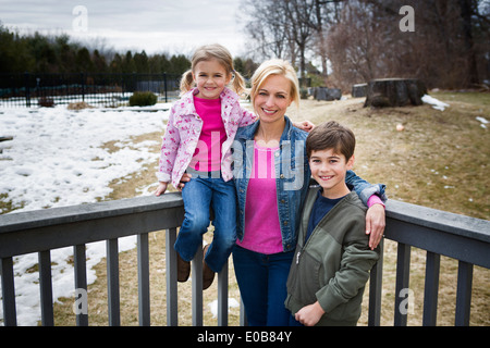 Portrait of mother and two children in park Stock Photo