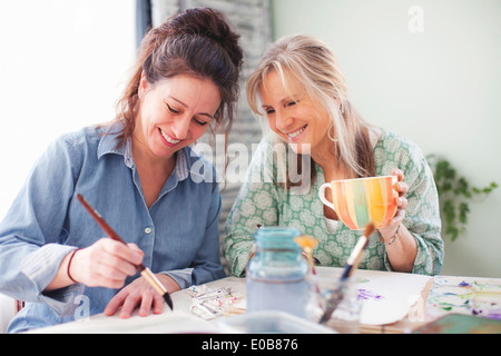 Two mature female artists painting in studio Stock Photo