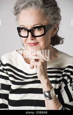 Portrait of senior woman, hand on chin