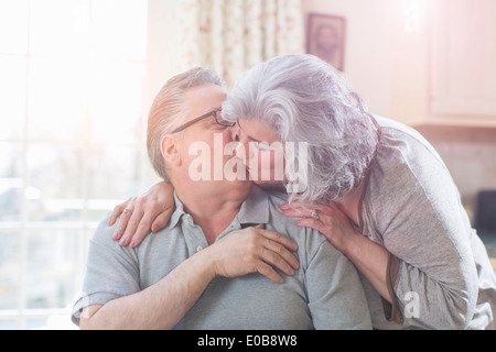 Affectionate mature adult couple kissing at home Stock Photo