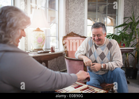 Mature couple at home playing backgammon Stock Photo