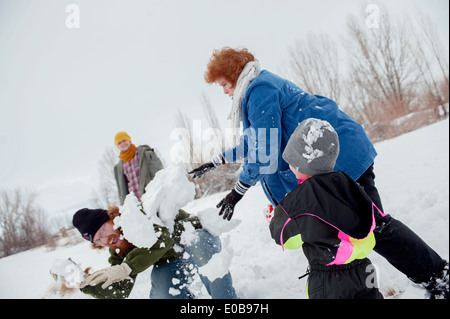 Family having snowball fight Stock Photo