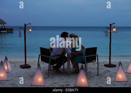 Couple Enjoying Late Meal In Outdoor Restaurant Stock Photo