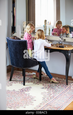 Two Girls Playing With Jewelry And Make Up Stock Photo