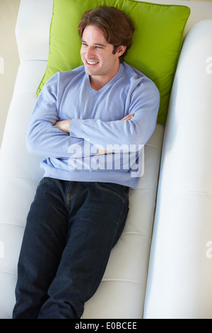 Overhead View Of Man Relaxing On Sofa Stock Photo