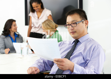 Portrait Of Businessman In Boardroom With Colleagues Stock Photo