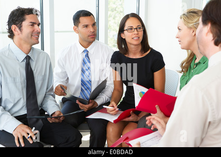 Businesspeople Having Informal Office Meeting Stock Photo