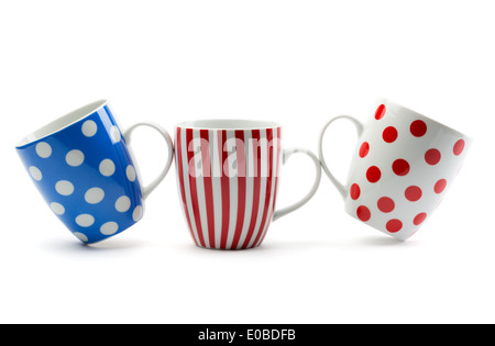 Three porcelain cup with stripes and dots. Isolate on white. Stock Photo