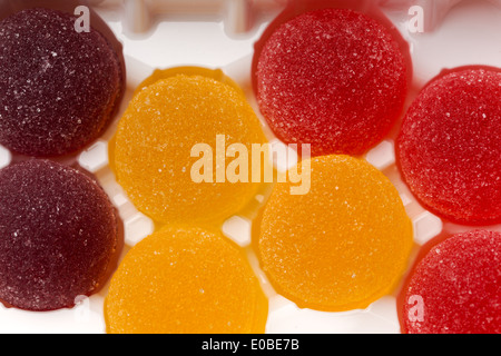Round jelly sprinkled with sugar in a plastic box Stock Photo