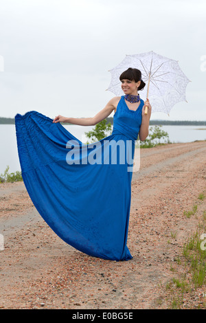 Beautiful dark haired model strolling through the woods. Stock Photo