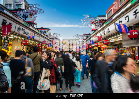 Nakamise-dori shopping street with Senso-ji temple in the background and blooming cherry trees, Asakusa district, Tokyo, Japan Stock Photo