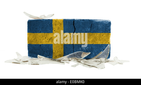 Brick with broken glass  violence concept  flag of Sweden Stock Photo