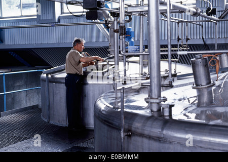 Scottish distillery worker at steel mash tun Stock Photo