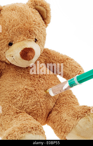 En teddy bear gets an injection. Inoculating and syringe., En Teddybaer bekommt eine Injektion. Impfen und Spritze. Stock Photo