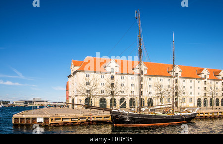 An old wooden ship in front of Eigtveds Pakhus, Conference center, Copenhagen, Denmark Stock Photo