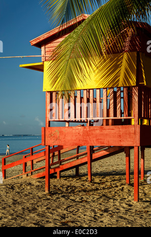 Lifeguard house and walker on beach, Luquillo Public Beach, Luquillo, Puerto Rico Stock Photo