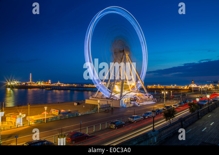 The Brighton Wheel and Pier spinning at night, Brighton, East Sussex Stock Photo