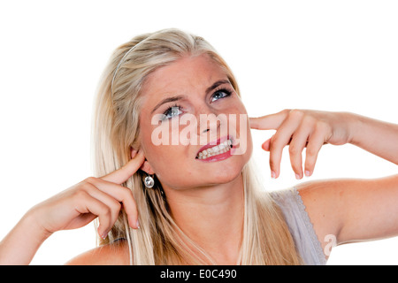 Young woman suffers from noise pollution, keeps closed to herself the ears., Junge Frau leidet unter Laermbelaestigung, haelt si Stock Photo