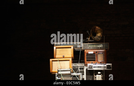 Tower - Stacks of Vintage Radios, stereo cassette deck, players and gramophone with black wall background Stock Photo