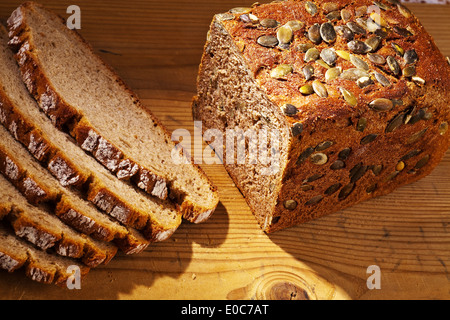 A fresh bread with pumpkin cores to the healthy food. Cakes and pastries of brown bread, Ein frisches Brot mit Kuerbiskernen zur Stock Photo